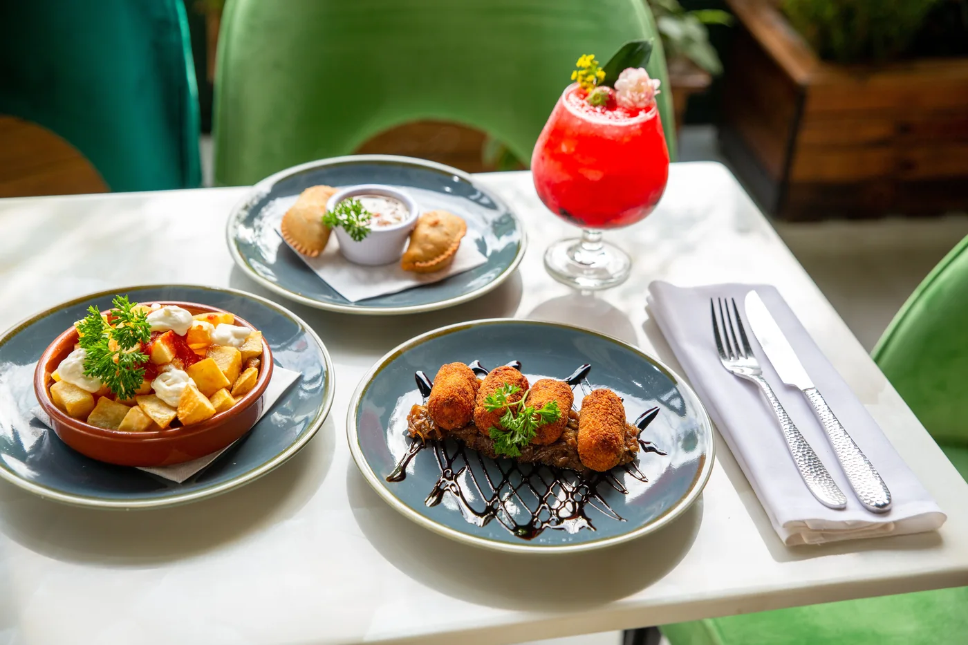 A spread of Spanish tapas and a glass of red wine
